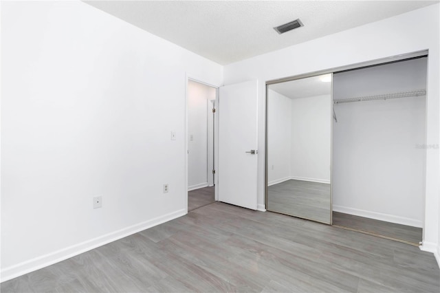 840 Center Ave Unit 80, Daytona Beach, FL 32117 - unfurnished bedroom with a closet and wood finished floors