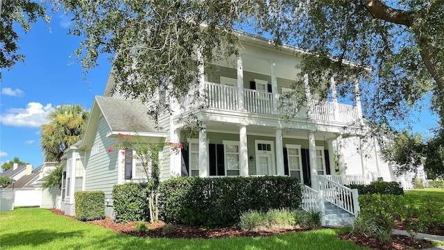 934 Westpark Dr, Celebration, FL 34747 - view of front of property with a balcony, covered porch, and a front yard