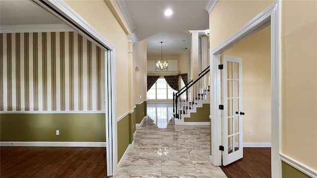 934 Westpark Dr, Celebration, FL 34747 - entrance foyer featuring crown molding, stairs, a chandelier, french doors, and arched walkways