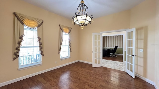 934 Westpark Dr, Celebration, FL 34747 - spare room with french doors, dark wood-style flooring, a chandelier, and a desk
