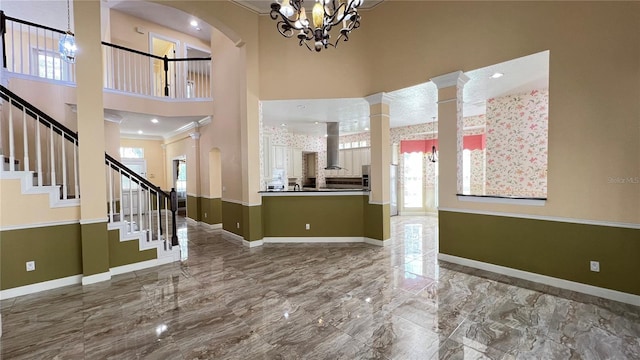 934 Westpark Dr, Celebration, FL 34747 - entrance foyer featuring a towering ceiling, ornamental molding, a chandelier, marble tiled floors, and stairway