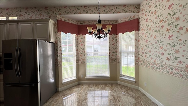 934 Westpark Dr, Celebration, FL 34747 - unfurnished dining area with wallpapered walls and a chandelier