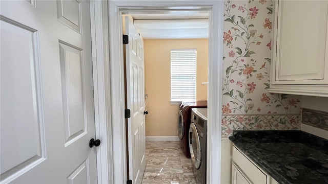 934 Westpark Dr, Celebration, FL 34747 - laundry room featuring washer and clothes dryer, light marble finish floors, cabinet space, and wallpapered walls