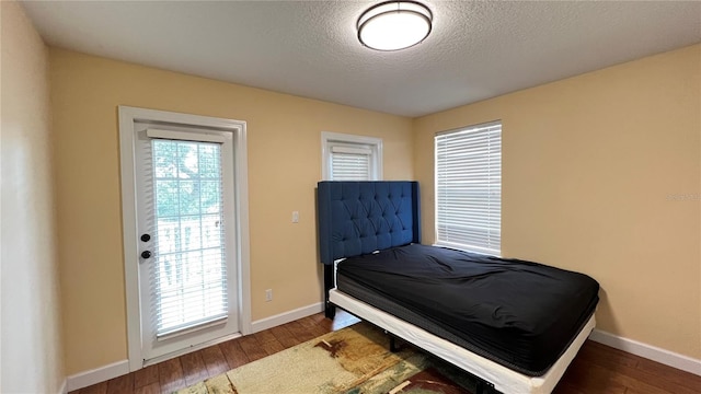 934 Westpark Dr, Celebration, FL 34747 - bedroom featuring wood-type flooring and a textured ceiling