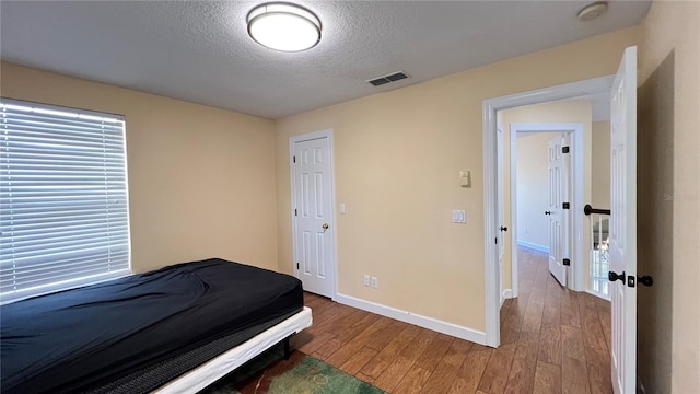 934 Westpark Dr, Celebration, FL 34747 - bedroom featuring wood finished floors and a textured ceiling