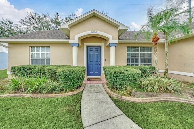4828 Jeanette Ct, Saint Cloud, FL 34771 - property entrance featuring stucco siding and roof with shingles