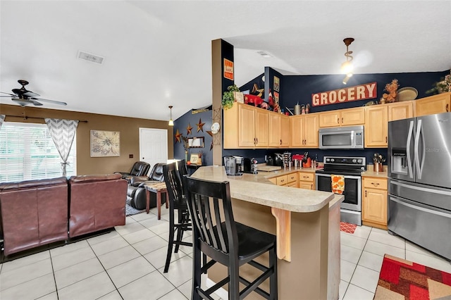 4828 Jeanette Ct, Saint Cloud, FL 34771 - kitchen featuring appliances with stainless steel finishes, light brown cabinetry, open floor plan, light countertops, and light tile patterned floors