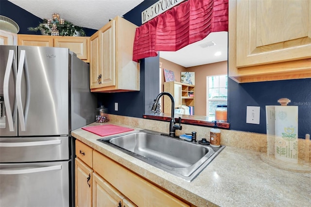 4828 Jeanette Ct, Saint Cloud, FL 34771 - kitchen with freestanding refrigerator, light brown cabinetry, and light countertops