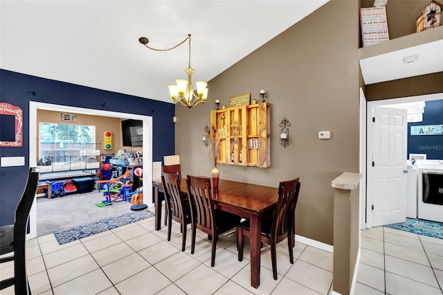 4828 Jeanette Ct, Saint Cloud, FL 34771 - dining space with a chandelier, lofted ceiling, washer / clothes dryer, light tile patterned floors, and light colored carpet