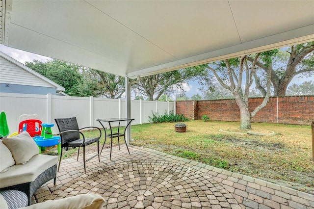 4828 Jeanette Ct, Saint Cloud, FL 34771 - fenced backyard featuring a patio and an outdoor fire pit