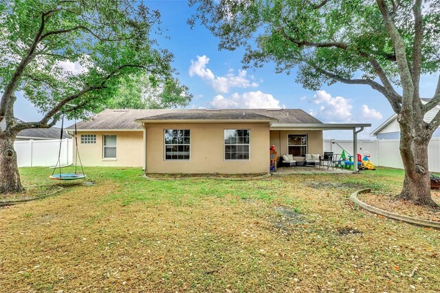 4828 Jeanette Ct, Saint Cloud, FL 34771 - rear view of house featuring stucco siding, a fenced backyard, a patio area, and an outdoor living space