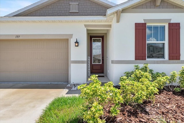 1717 Hilltop Dr, Dundee, FL 33838 - entrance to property with stucco siding, an attached garage, and driveway