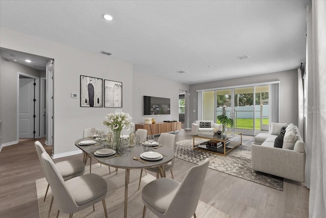 1717 Hilltop Dr, Dundee, FL 33838 - dining space with wood finished floors and recessed lighting