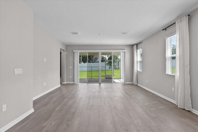 1717 Hilltop Dr, Dundee, FL 33838 - spare room featuring wood finished floors and a textured ceiling