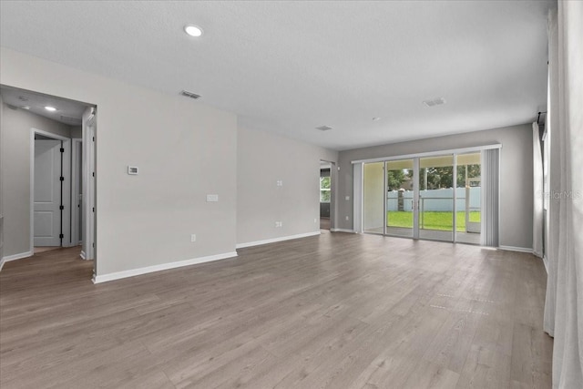 1717 Hilltop Dr, Dundee, FL 33838 - empty room featuring light wood-type flooring and recessed lighting