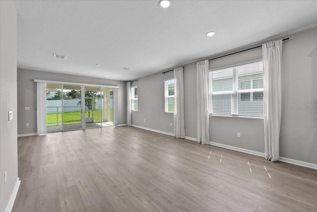 1717 Hilltop Dr, Dundee, FL 33838 - empty room with wood finished floors, a textured ceiling, and recessed lighting