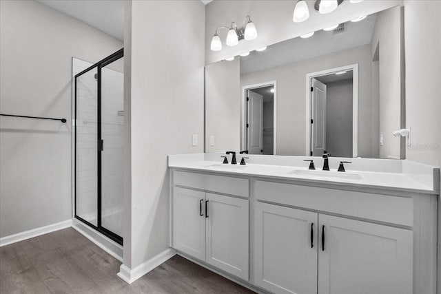 1717 Hilltop Dr, Dundee, FL 33838 - full bath with wood finished floors, a shower stall, and double vanity