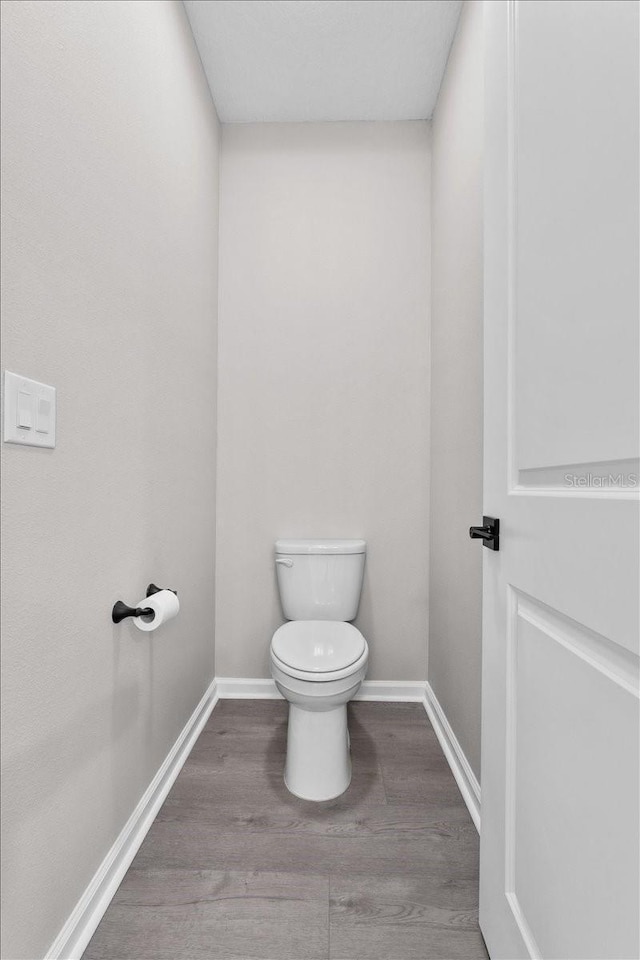 1717 Hilltop Dr, Dundee, FL 33838 - bathroom featuring wood finished floors and toilet