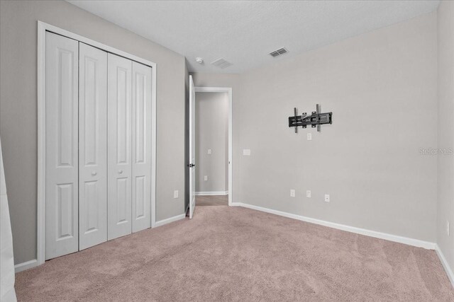 1717 Hilltop Dr, Dundee, FL 33838 - unfurnished bedroom featuring carpet and a closet