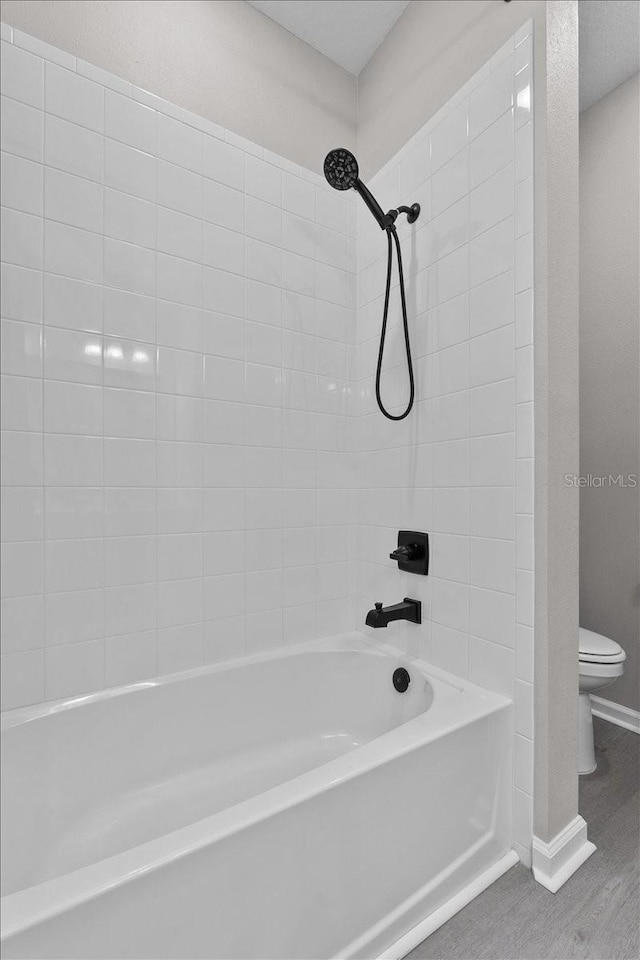 1717 Hilltop Dr, Dundee, FL 33838 - full bath with shower / bath combination and wood finished floors