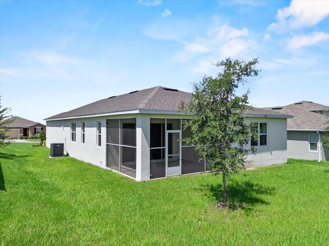 1717 Hilltop Dr, Dundee, FL 33838 - back of house with stucco siding, a sunroom, and a lawn