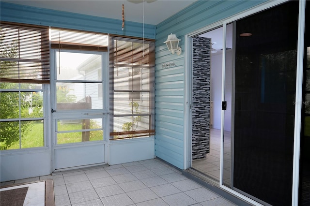 926 Chula Ct, Lady Lake, FL 32159 - spare room with light tile patterned floors, healthy amount of natural light, and wood walls