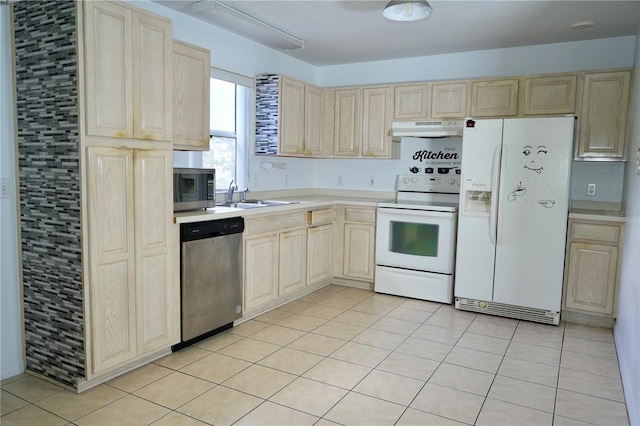 926 Chula Ct, Lady Lake, FL 32159 - kitchen featuring appliances with stainless steel finishes, under cabinet range hood, light brown cabinetry, and light countertops
