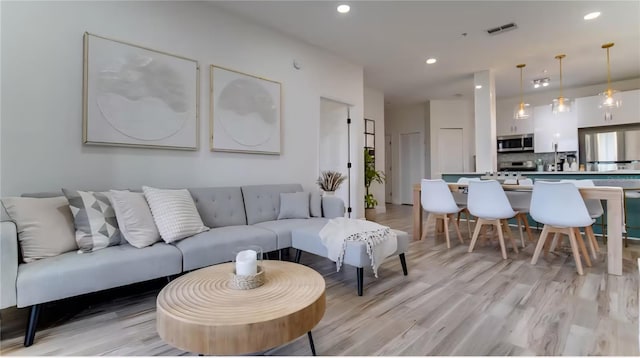 8103 Coconut Palm Way Unit 203, Kissimmee, FL 34747 - living room with light wood-type flooring and recessed lighting