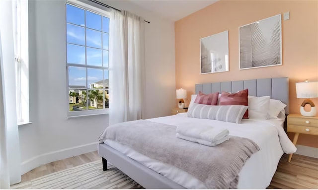 8103 Coconut Palm Way Unit 203, Kissimmee, FL 34747 - bedroom featuring wood finished floors and multiple windows