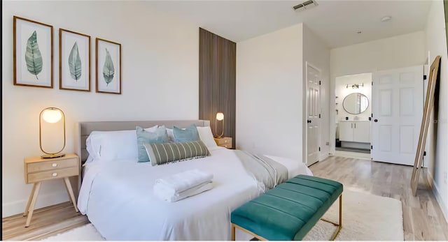 8103 Coconut Palm Way Unit 203, Kissimmee, FL 34747 - bedroom featuring wood finished floors and ensuite bath