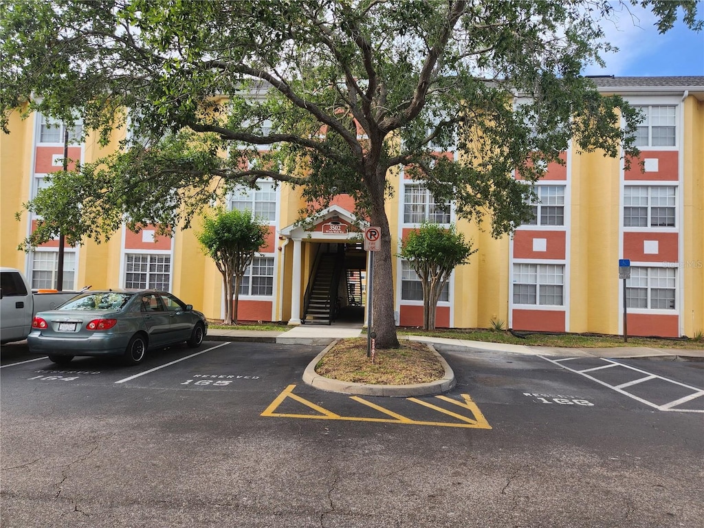 3502 Windy Walk Way Unit 2-308, Orlando, FL 32837 - view of building exterior with uncovered parking and stairway