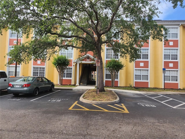 3502 Windy Walk Way Unit 2-308, Orlando, FL 32837 - view of building exterior with uncovered parking and stairway