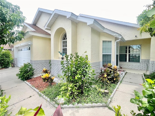 162 Seneca Point Trl, Kissimmee, FL 34746 - view of property exterior featuring stucco siding, a garage, and concrete driveway
