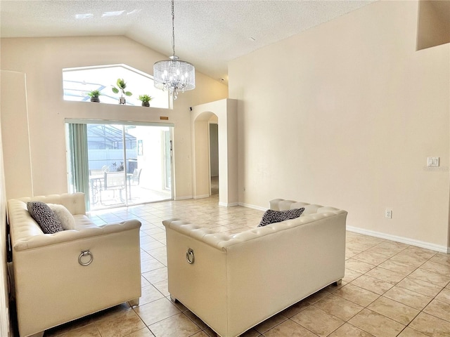 162 Seneca Point Trl, Kissimmee, FL 34746 - living area featuring arched walkways, a chandelier, a textured ceiling, light tile patterned floors, and high vaulted ceiling