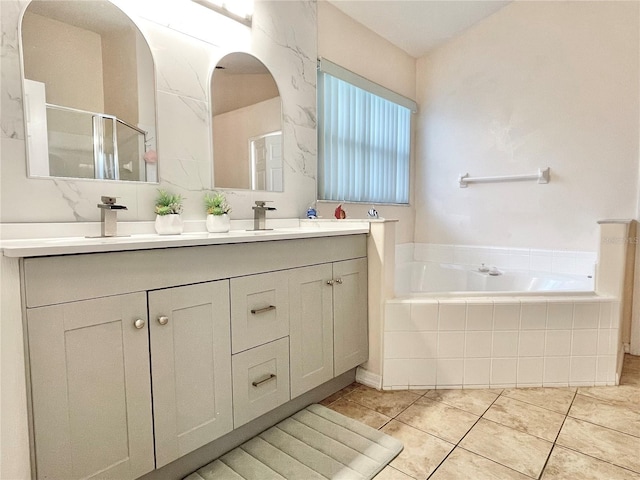 162 Seneca Point Trl, Kissimmee, FL 34746 - full bath with double vanity, a garden tub, a shower stall, and tile patterned flooring