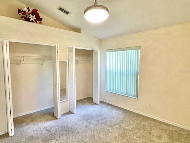 162 Seneca Point Trl, Kissimmee, FL 34746 - unfurnished bedroom with multiple closets, lofted ceiling, and carpet floors