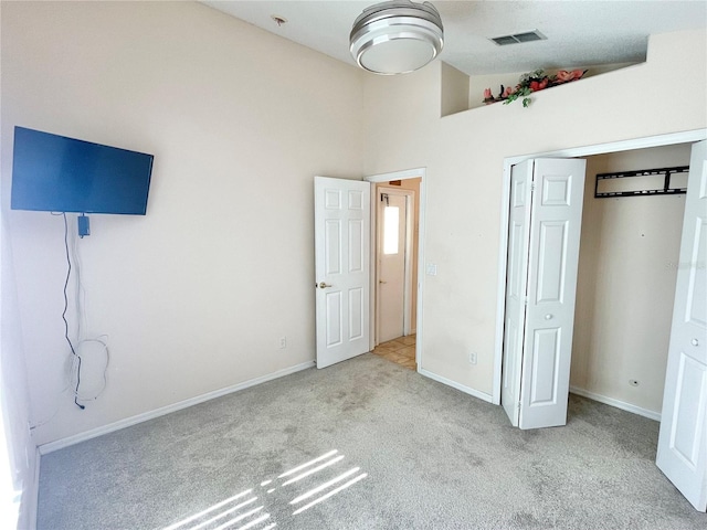 162 Seneca Point Trl, Kissimmee, FL 34746 - unfurnished bedroom with carpet, a closet, and a towering ceiling