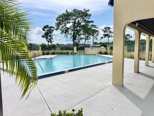 162 Seneca Point Trl, Kissimmee, FL 34746 - community pool with a patio