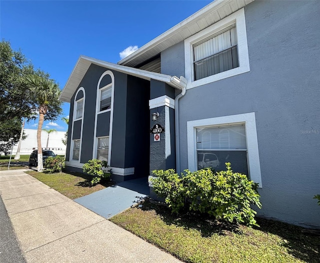 4160 Pershing Pointe Pl Unit 1, Orlando, FL 32822 - doorway to property featuring stucco siding