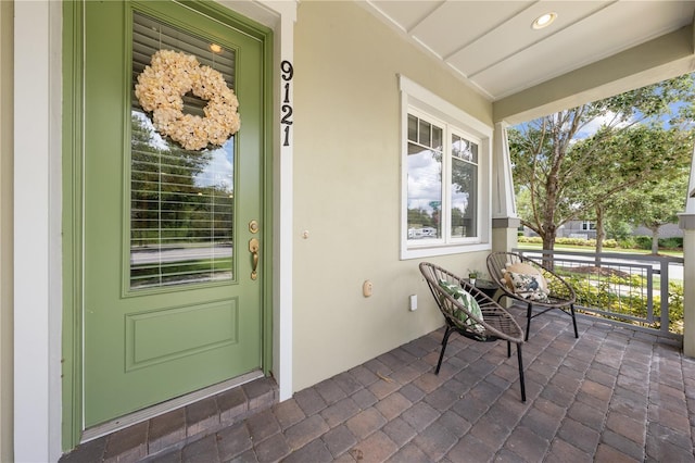 9121 Laureate Blvd, Orlando, FL 32827 - entrance to property featuring covered porch and stucco siding