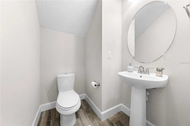 9121 Laureate Blvd, Orlando, FL 32827 - half bath featuring wood finished floors, a textured ceiling, and vaulted ceiling