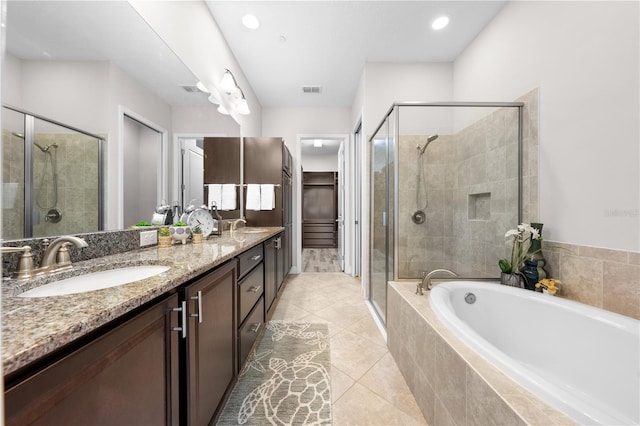 9121 Laureate Blvd, Orlando, FL 32827 - bathroom with a stall shower, a garden tub, double vanity, tile patterned flooring, and recessed lighting
