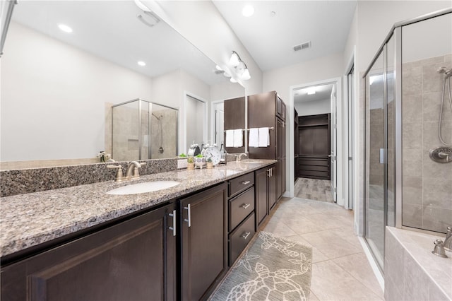 9121 Laureate Blvd, Orlando, FL 32827 - bathroom with a stall shower, double vanity, tile patterned flooring, a walk in closet, and a bathtub