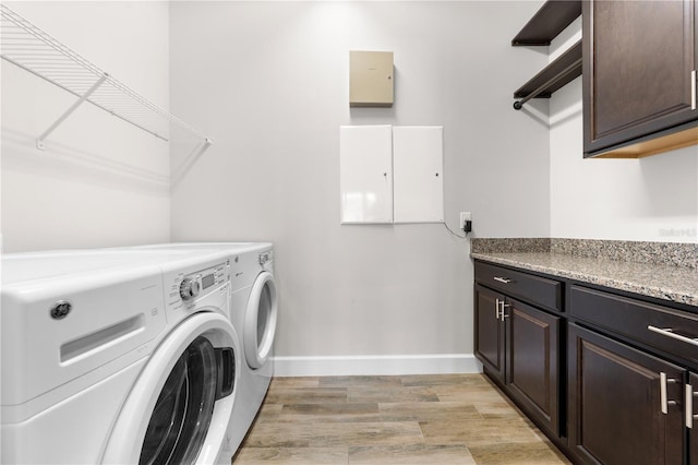 9121 Laureate Blvd, Orlando, FL 32827 - laundry area with cabinet space, washing machine and clothes dryer, and light wood-style floors