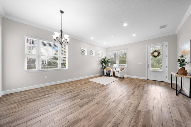 9121 Laureate Blvd, Orlando, FL 32827 - entrance foyer with ornamental molding, light wood-style floors, a chandelier, and recessed lighting