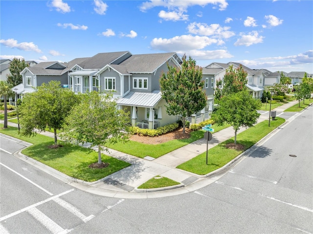 9121 Laureate Blvd, Orlando, FL 32827 - view of front of home featuring a residential view, a front lawn, and a metal roof