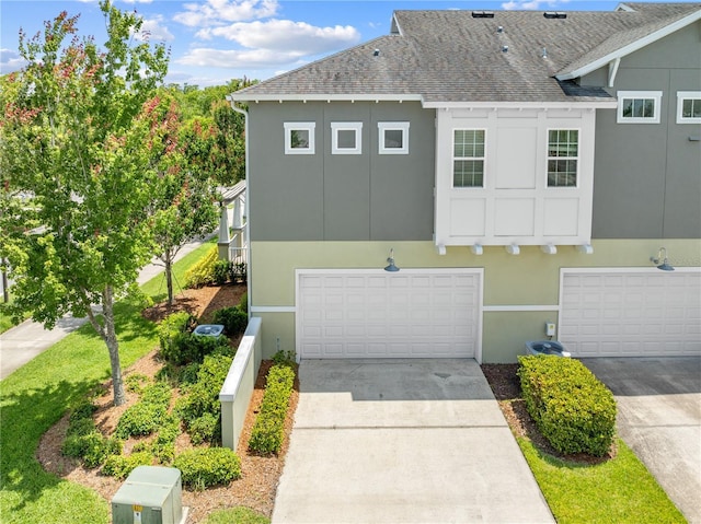 9121 Laureate Blvd, Orlando, FL 32827 - view of front facade featuring a shingled roof, an attached garage, driveway, and stucco siding