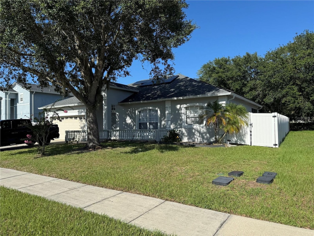 478 Acacia Tree Way, Kissimmee, FL 34758 - ranch-style home featuring solar panels and an attached garage