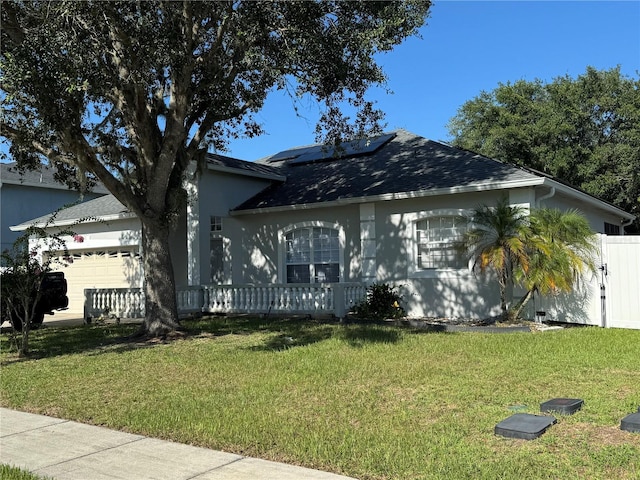 478 Acacia Tree Way, Kissimmee, FL 34758 - view of front of property featuring a garage, roof mounted solar panels, and a shingled roof