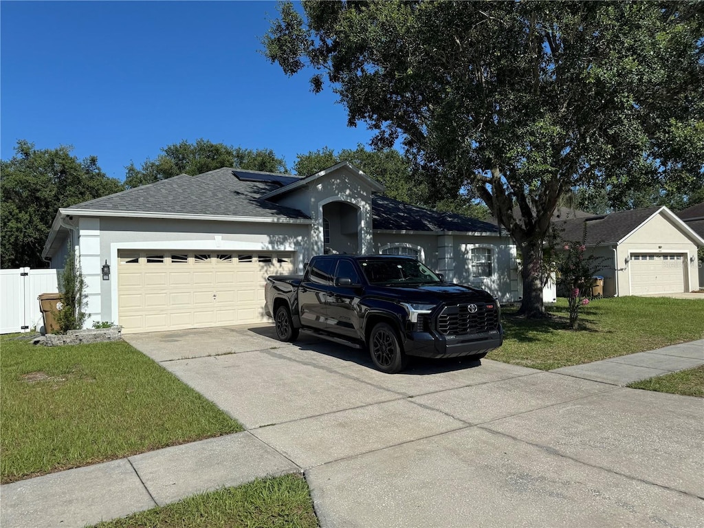 478 Acacia Tree Way, Kissimmee, FL 34758 - single story home featuring concrete driveway, a garage, stucco siding, and roof with shingles
